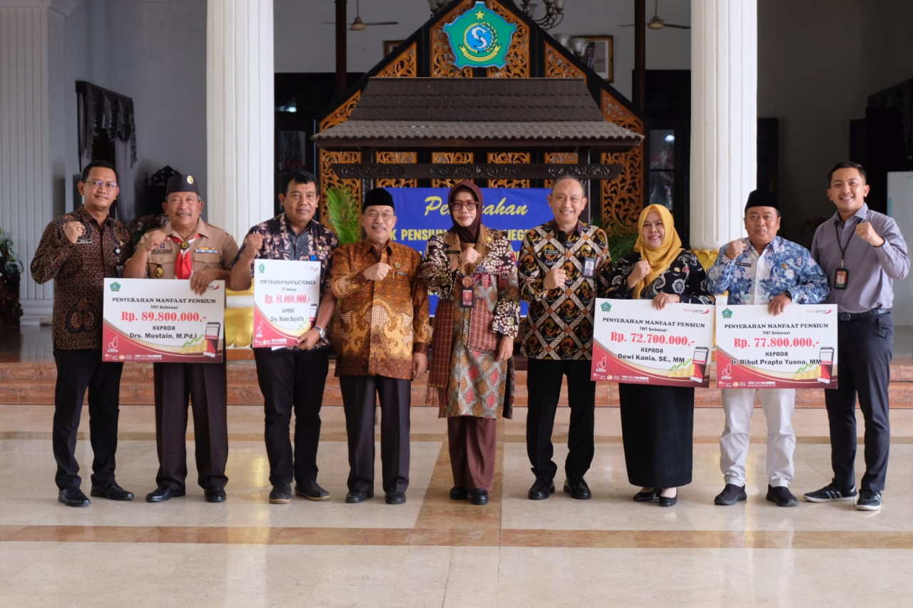 Sekda Fenny foto bersama dengan para purna tugas usai menyerahkan jaminan hari tua. (Ist)