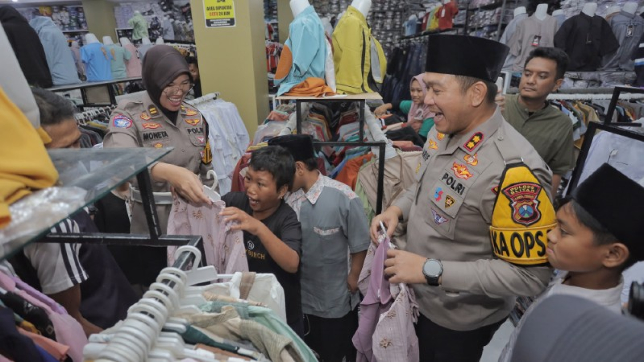 Kapolres Blitar menyerahkan berbagai bantuan berupa sarung, songkok, baju koko, mukena, dan busana muslim kepada anak yatim piatu. Tampak Kapolres saat mengajak berbelanja bersama anak yatim. (ist)