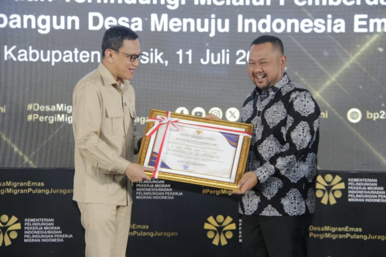 Menteri PPMI menyerahkan plakat kepada Bupati Gresik Fandi Akhmad Yani. (ist)