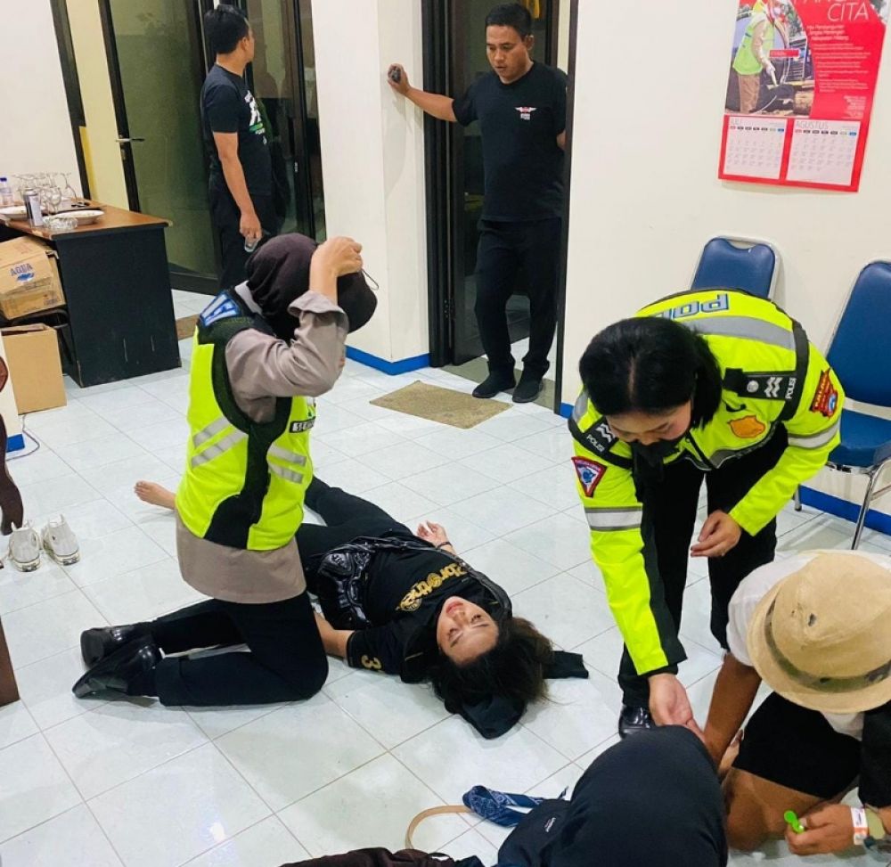 Seorang Influencer masih tergeletak dalam kondisi tak sadarkan diri setelah diselamatkan Polwan saat berdesakan di Stadion Kanjuruhan. (Ist) 