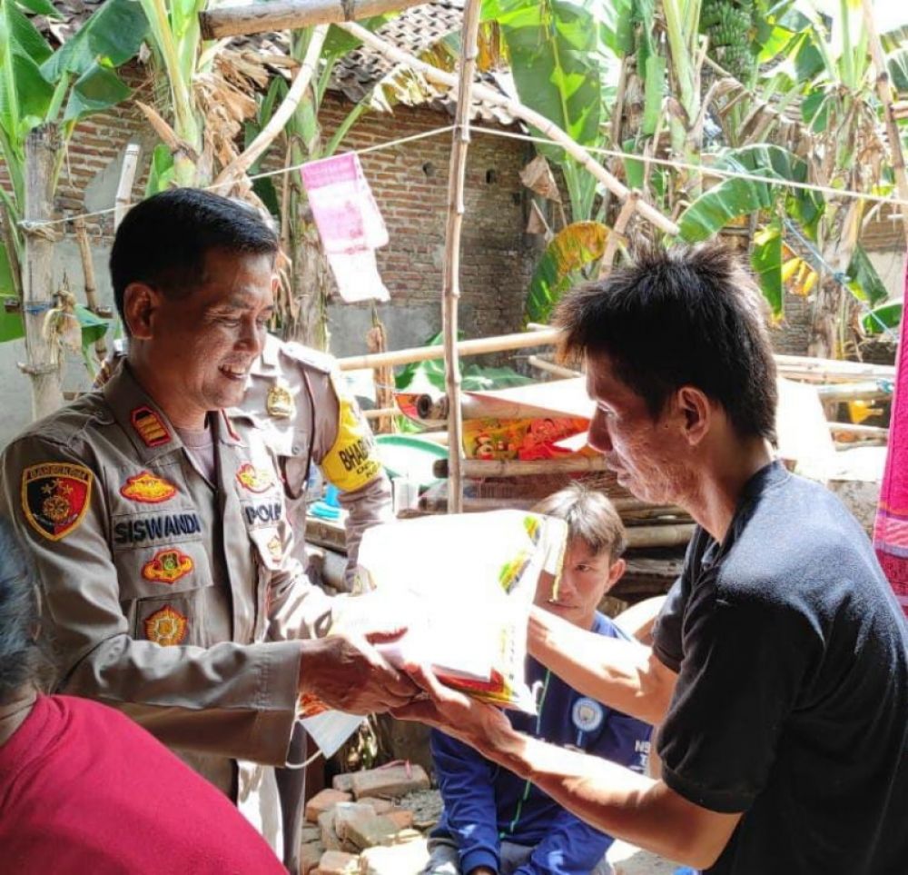 Kapolsek Semen Kabupaten Kediri, AKP Siswandi dalam suatu kesempatan berikan bantuan paket sembako kepada warga terdampak kenaikan harga BBM. (Ist) 